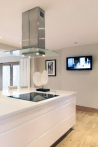 High gloss modern bespoke kitchen with extrctor and hi tec appliances