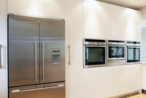 bank of high quality neff appliances in ultra modern high gloss kitchen